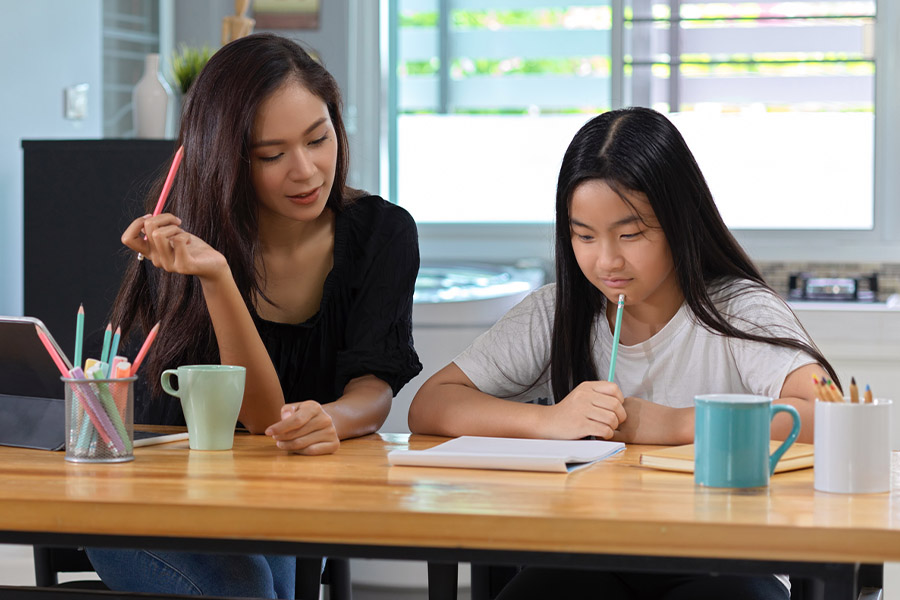 student and tutor together at a desk in Alameda